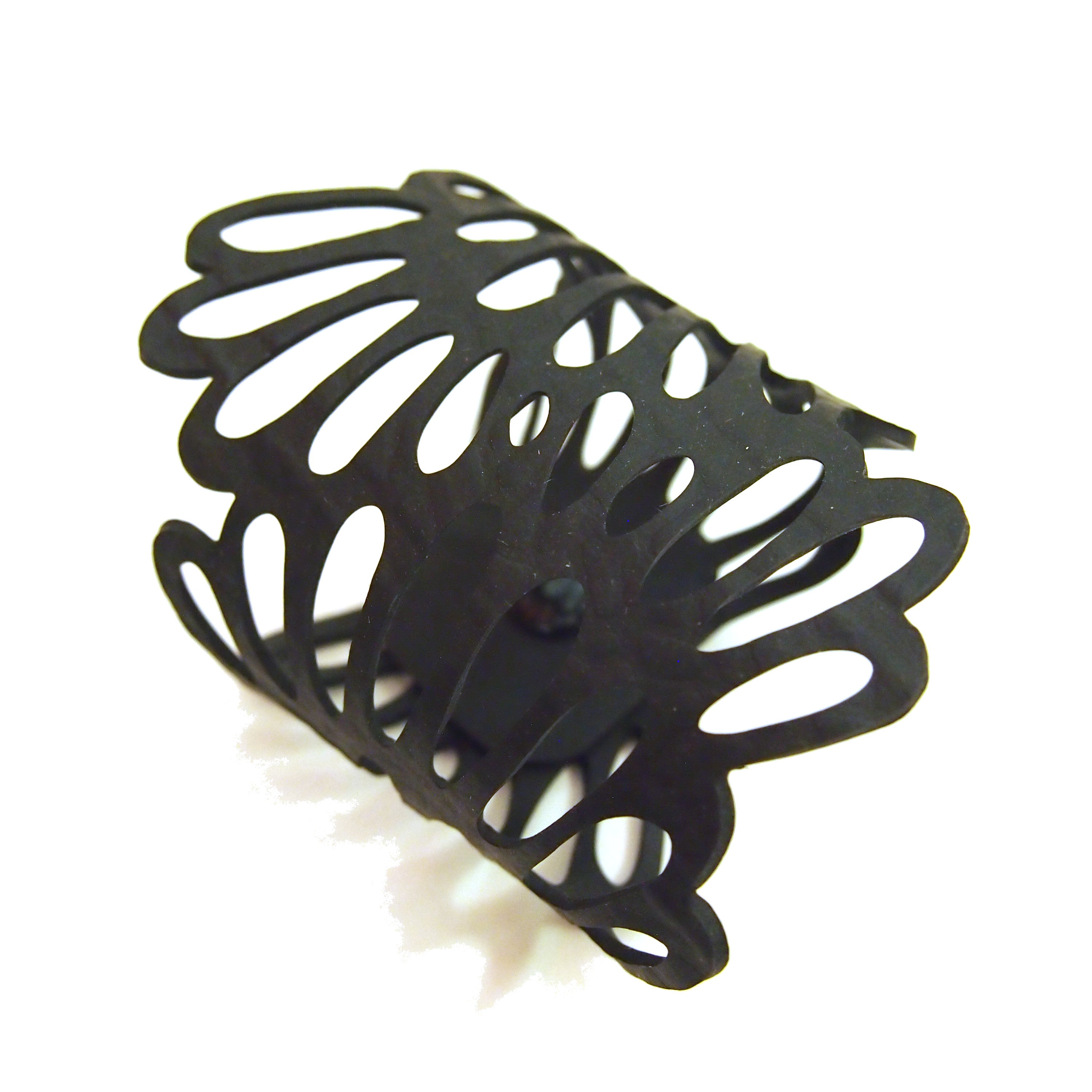 Black recycled rubber bracelet by Paguro Upcycle with intricate cutout butterfly wing design