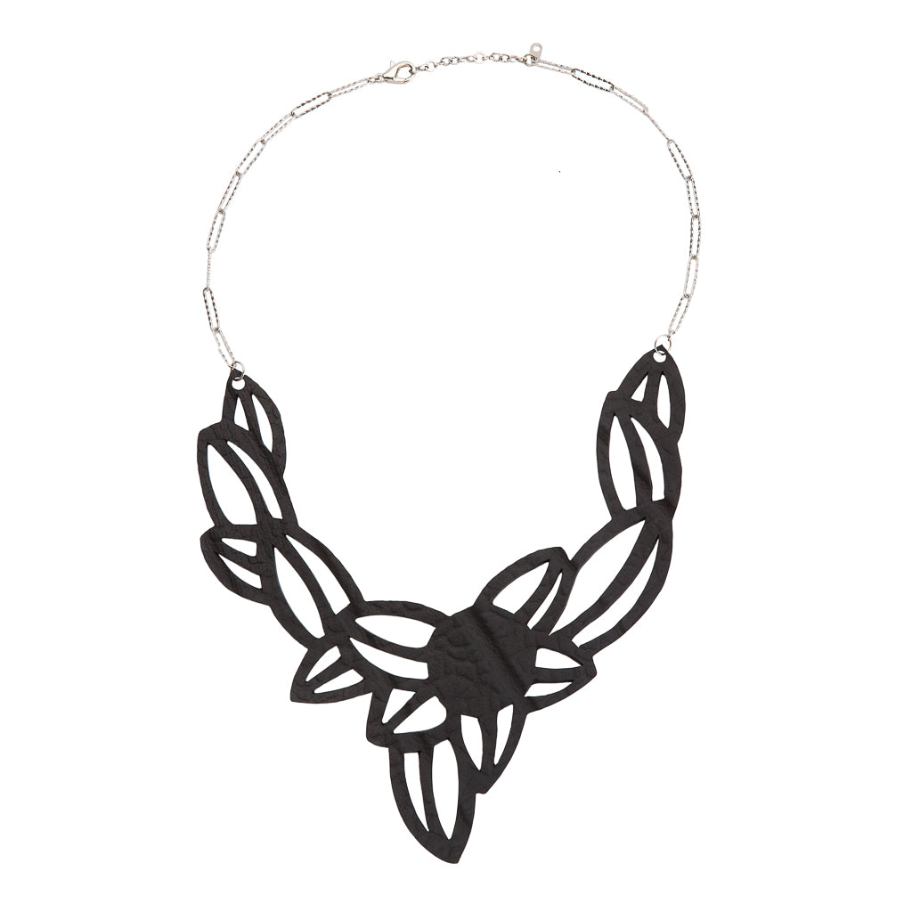 Paguro Upcycle vegan inner tube necklace with black cutout design and silver chain