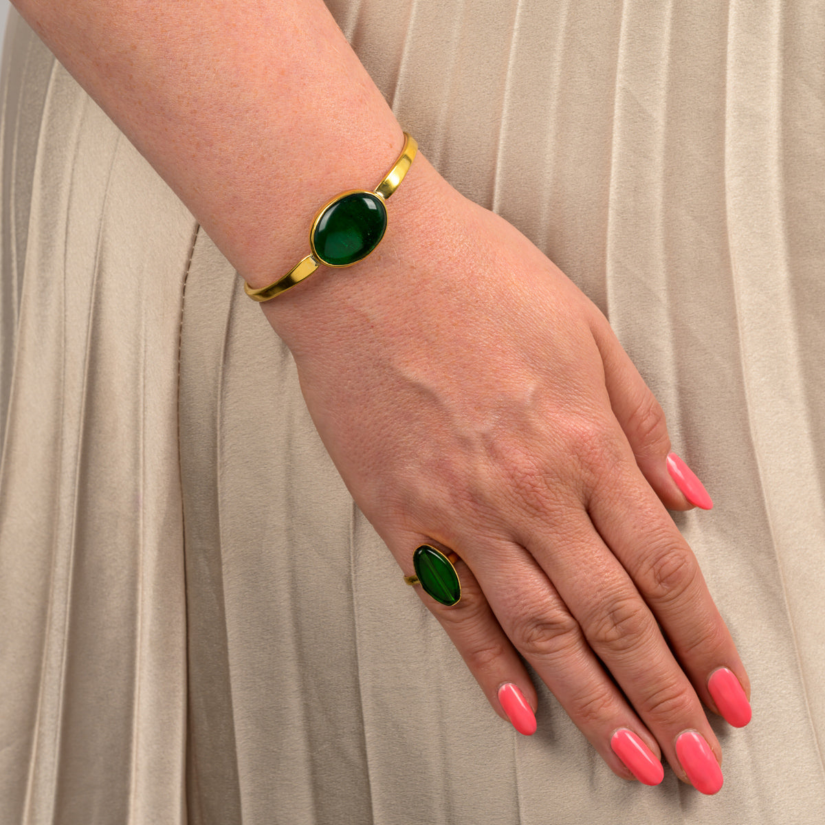 Paguro Upcycle recycled brass & glass bangle featuring a green stone on a gold band