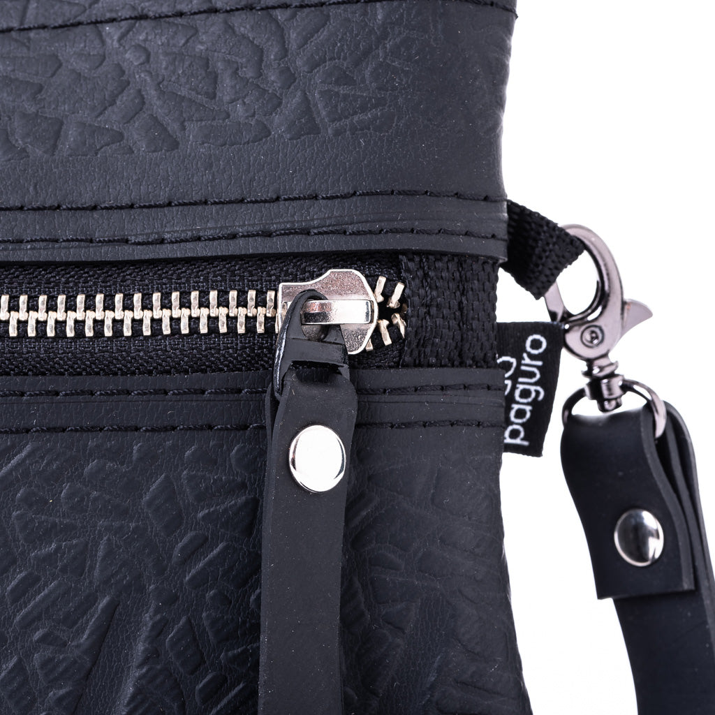 Close-up of black vegan wristlet pouch by Paguro Upcycle with zipper and detachable strap
