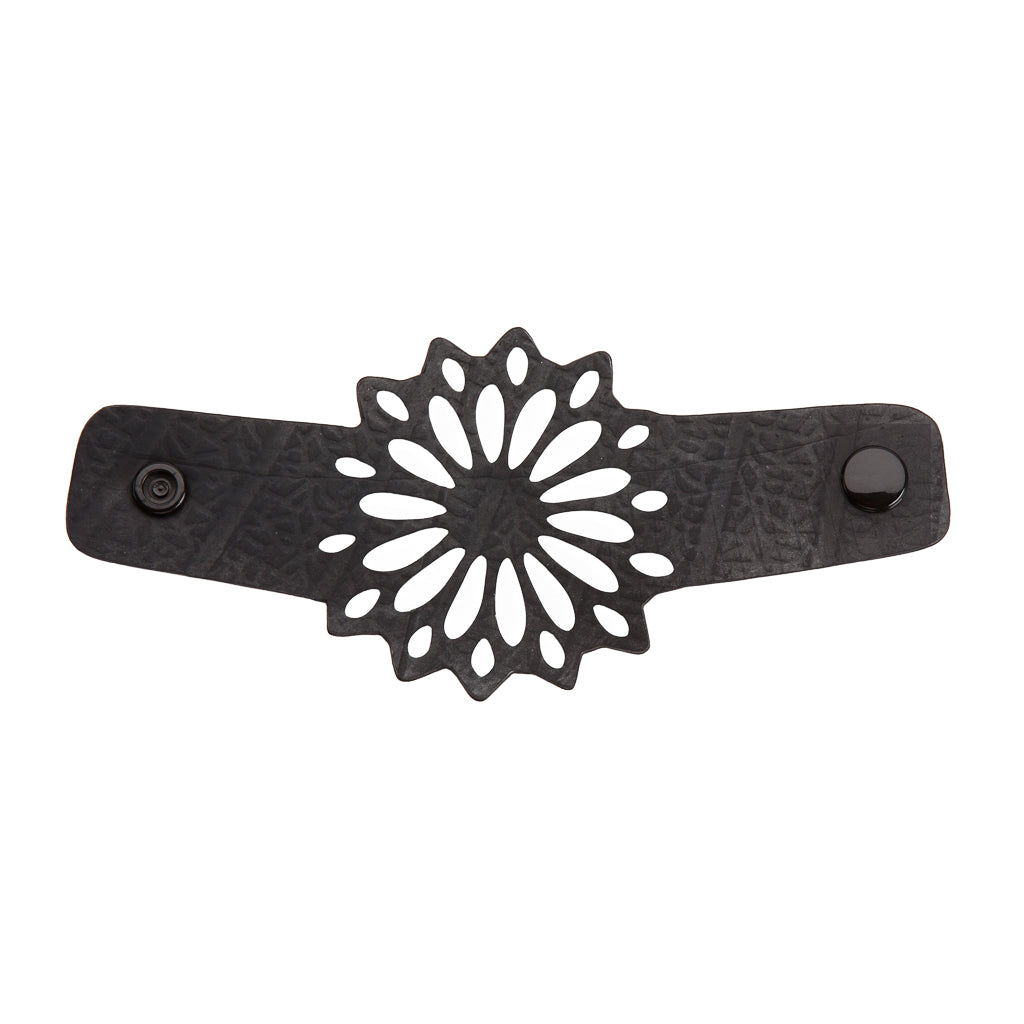 Paguro Upcycle black recycled rubber bracelet with floral cutout design and snap closure textured band
