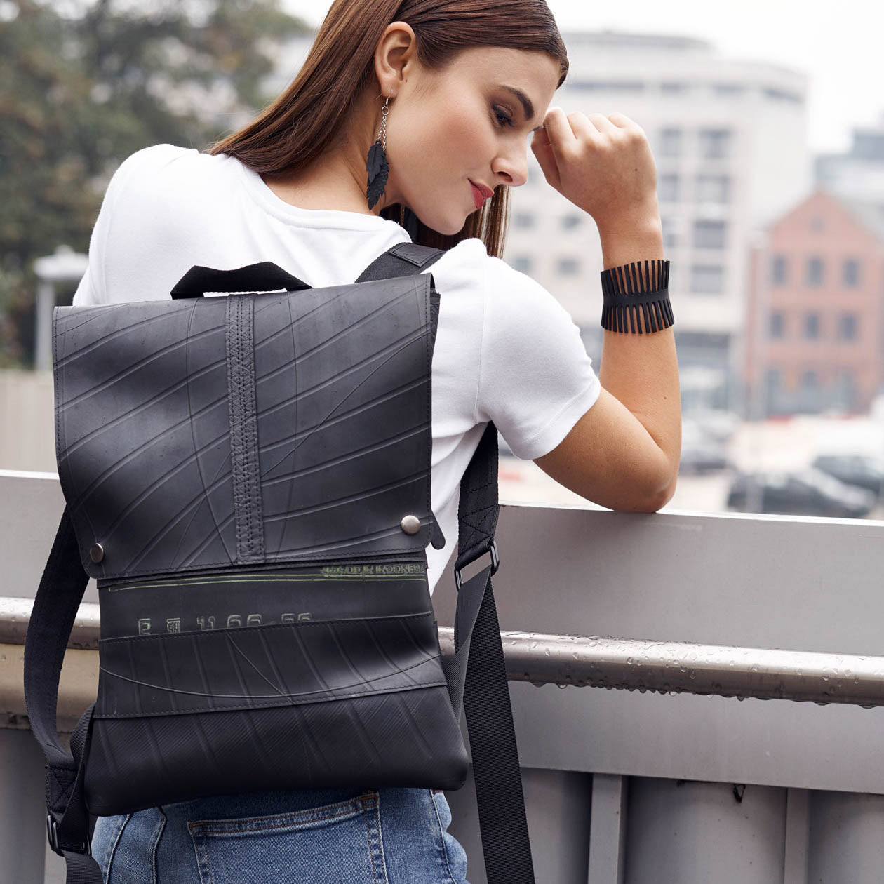 Paguro Upcycle recycled rubber bracelet cuff worn by model with upcycled rubber backpack urban style