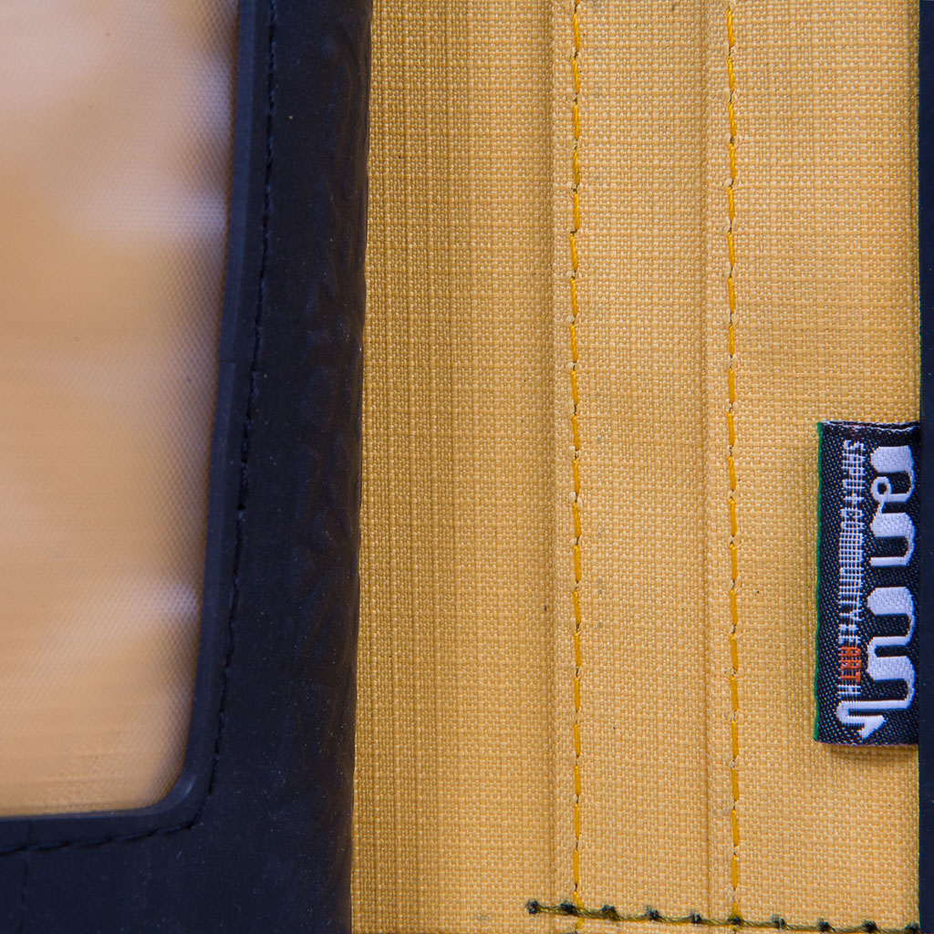 Paguro Upcycle recycled wallet with coin compartment featuring yellow fabric and black trim close-up