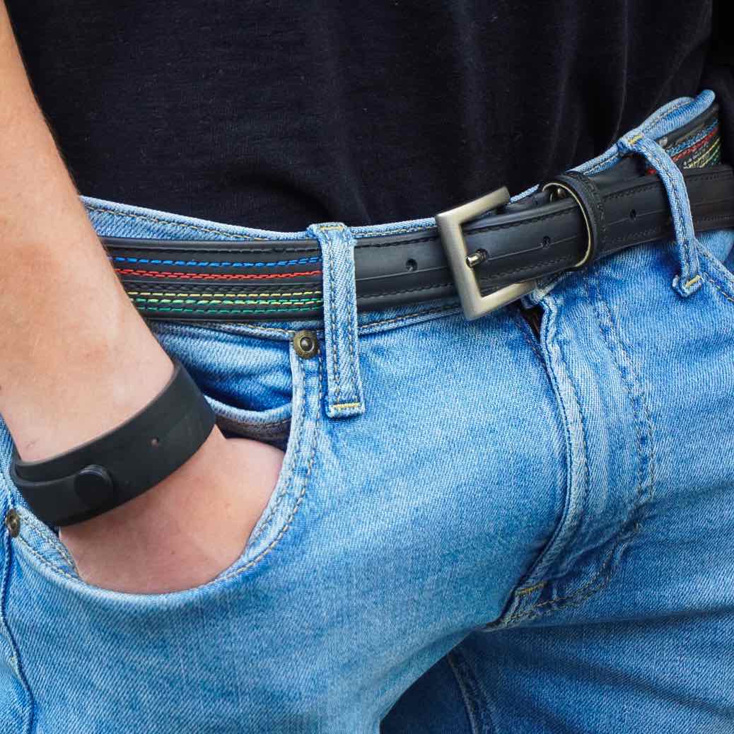 Upcycled inner tube bracelet worn on wrist with blue jeans and black belt by Paguro Upcycle