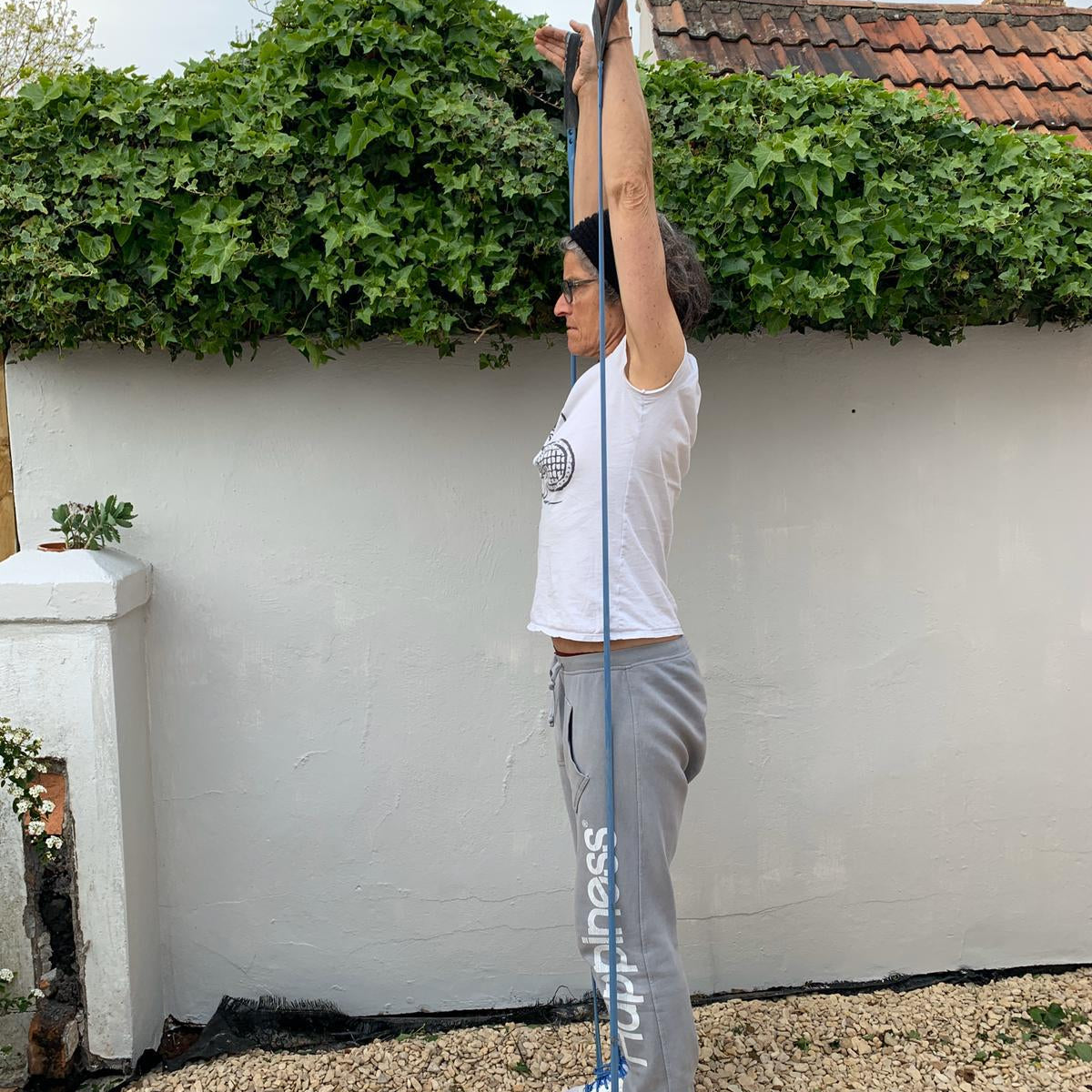 Woman exercising outdoors using Paguro Upcycle upcycled resistance band from bicycle inner tube for stretching