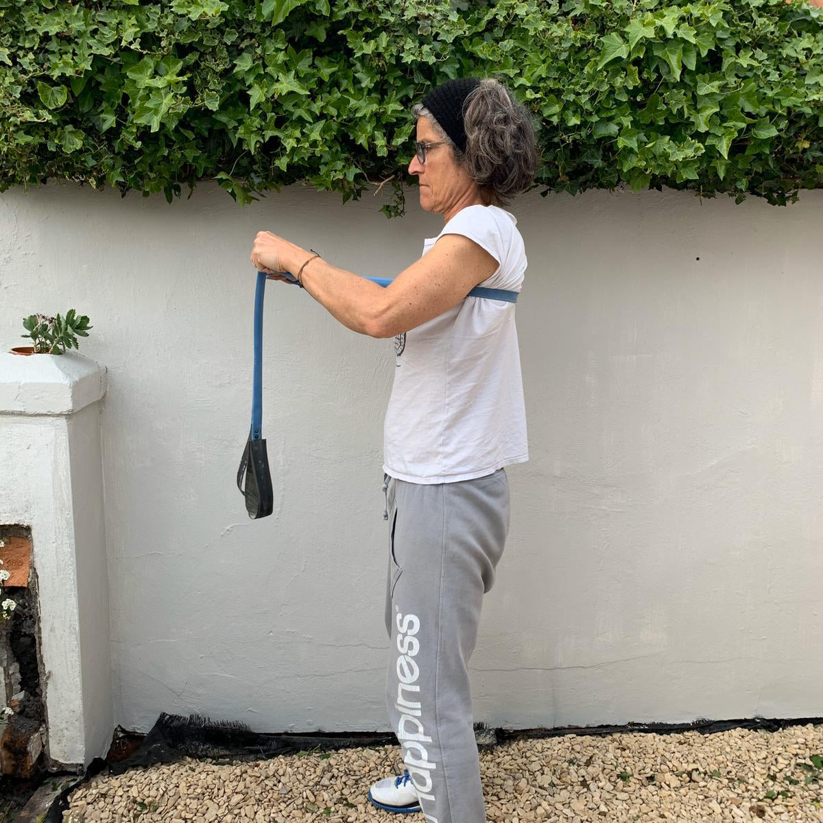 Woman using a Paguro Upcycle bicycle inner tube upcycled resistance band for exercise outdoors