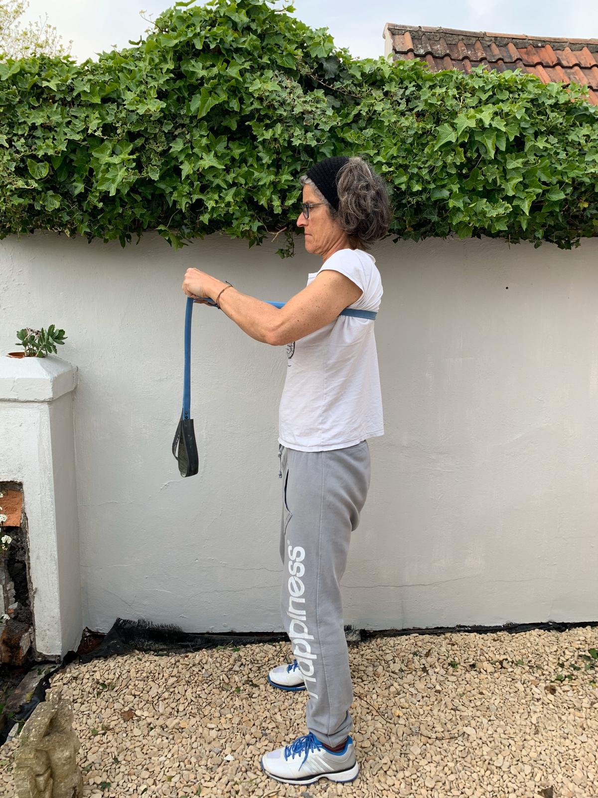 Woman using a Paguro Upcycle bicycle inner tube upcycled resistance band for exercise outdoors